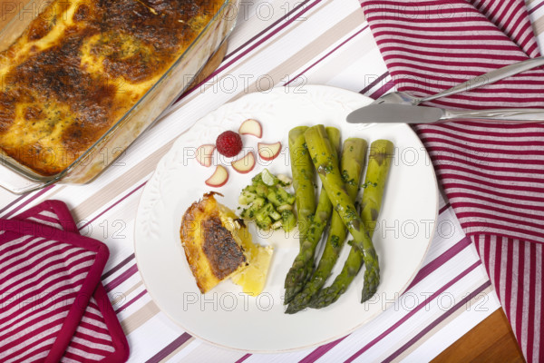 South German cuisine, green asparagus with rhubarb vinaigrette and potato gratin, healthy,