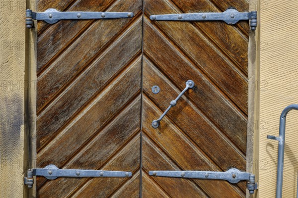 Detail of a historic iron-framed wooden door in the outer wall of the Old Palace in Stuttgart,