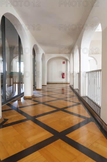 Modern hallway with arches and a striking wooden floor, bright atmosphere, Kirchheim Teck, Germany,