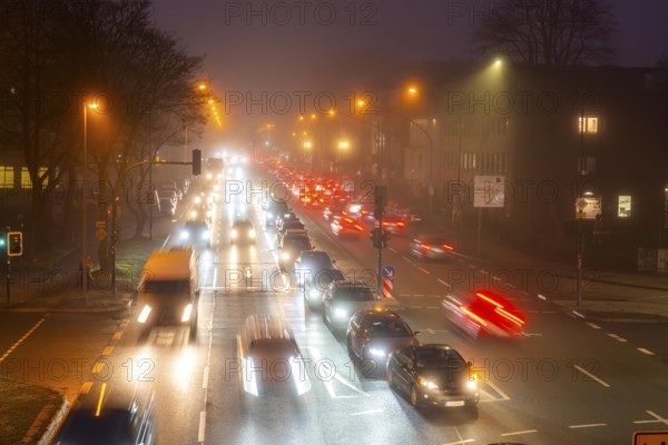 Dense fog, with visibility sometimes less than 100 metres, city centre traffic at rush hour on