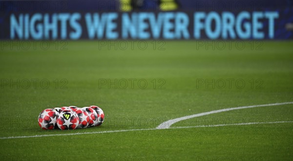 Adidas Football Pro 3rd match balls, lying on grass, behind them perimeter advertising NIGHTS WE
