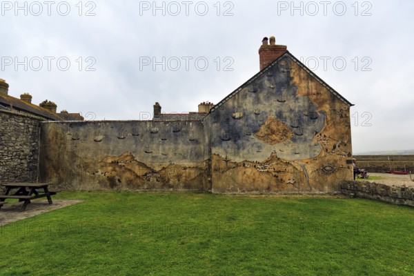 Façade with mural, St Michael's Mount, tidal island with castle, rain clouds, Marazion, Cornwall,
