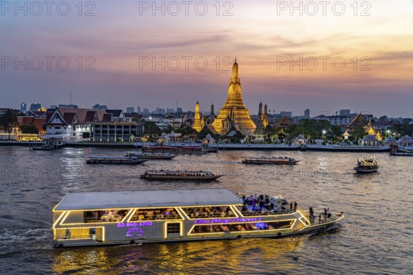 The Buddhist temple Wat Arun or Temple of Dawn and the Chao-Phraya River at dusk, Bangkok,