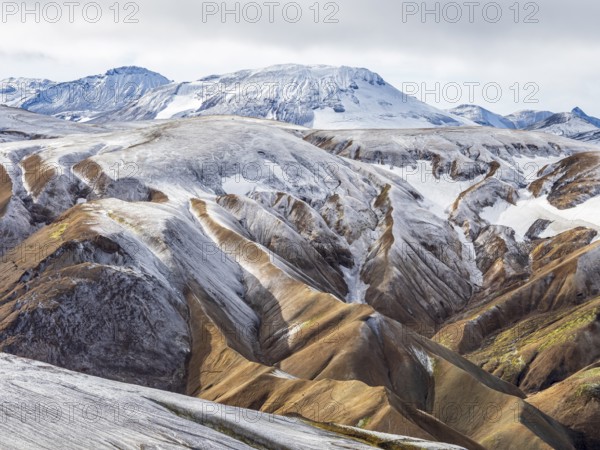Early snow on the colorful rhyolite mountains, Landmannalaugar, Fjallabak Nature Reserve, Iceland,