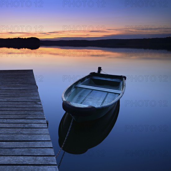 Quiet lake with jetty and rowing boat after sunset at dusk, Großer Lychensee, Lychen, Brandenburg,