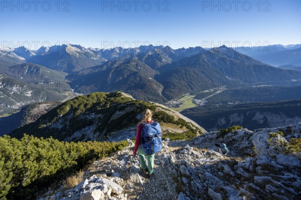 Mountaineer descending the summit of the Große Arnspitze, mountain panorama with Karwendel