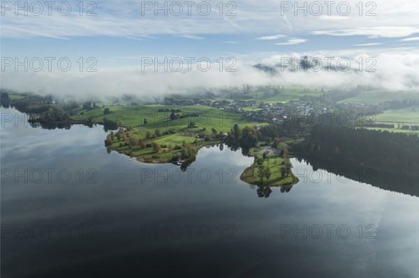 Sports facility and bathing area, lake Rottachsee, village Petersthal, mountains covered with fog,