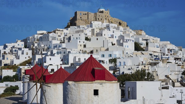 Castle and windmills above white houses under a sunny sky, Querini Castle, Chora, Astypalea,
