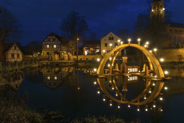 Floating double candle arch from the Ore Mountains with model of the church on the village pond,