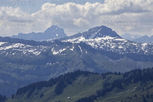 View from Hochgrat of imposing snow-covered Alps with clouds and blue sky, Oberstaufen, Bavaria,