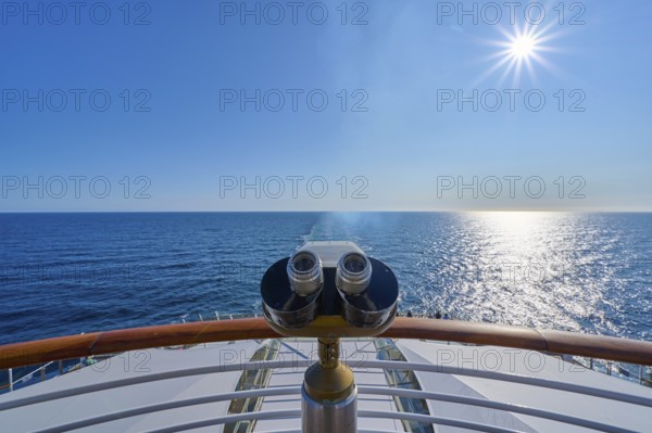 View from the ship's deck, Mein Schiff 6, under bright sunshine and blue sky, binoculars installed