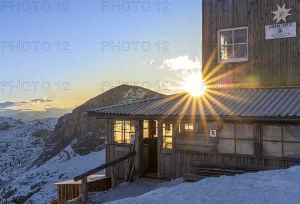 Sun shining through the windows of a snow-covered mountain hut, Simonyhütte, Upper Austria,