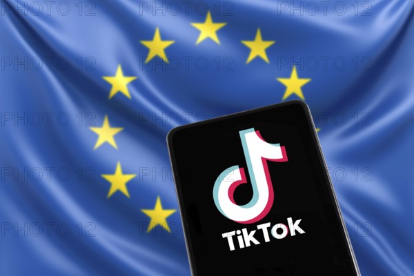 TikTok logo from China with EU European Union flag social media on a mobile phone in Stuttgart,