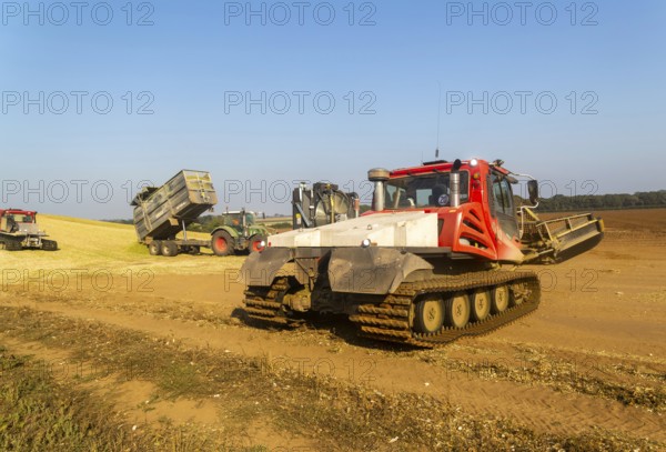 Piston Bully tracked bulldozer vehicles building silage clamp of sweetcorn maize in field stored
