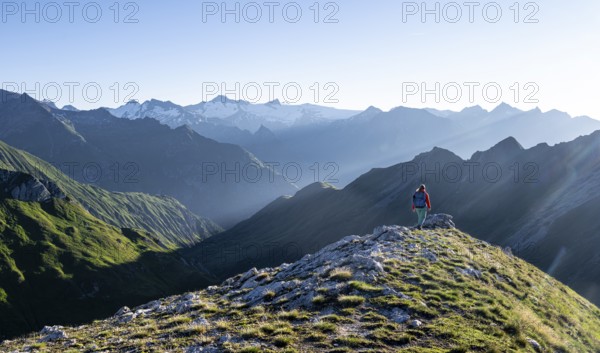 Hiker enjoying the mountain panorama in the morning, Venediger group, behind Dreiherrenkopf,