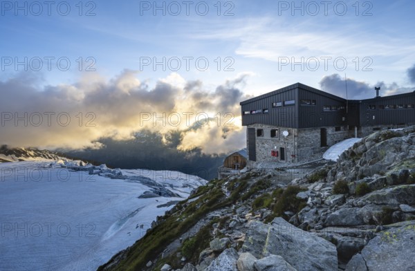 Mountain hut Refuge Albert 1er, high alpine mountain landscape at sunset, Glacier du Tour,