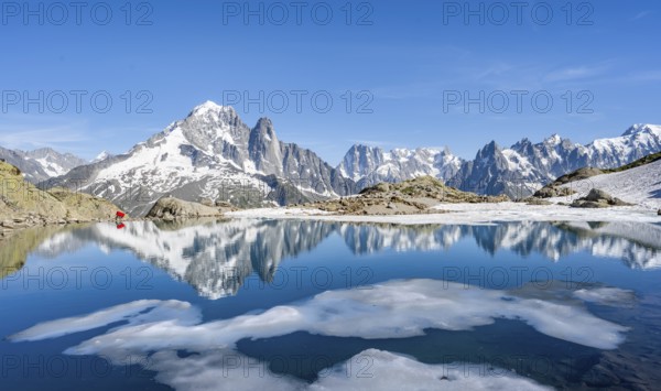 Mountain landscape with mountain lake and ice floe, water reflection in Lac Blanc, mountain peak,