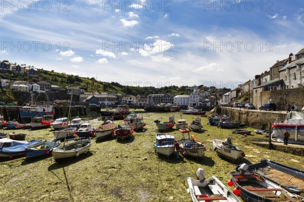 Fishing boats in tidal harbour, low tide, Mevagissey, St Austell, Cornwall, England, Great Britain