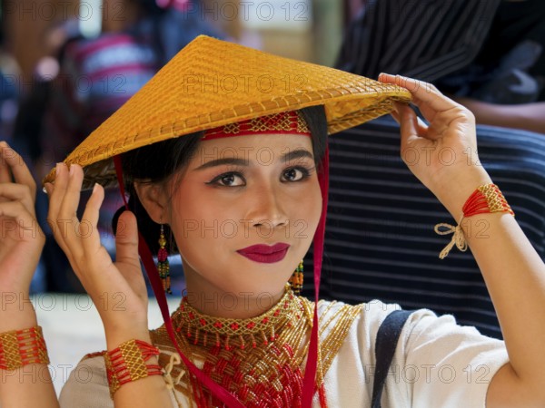 Toraja woman in traditional colourful clothing with rice straw hat, portrait, Tana Toraja,