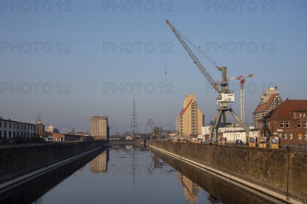 Quiet harbour view with cranes and water in the morning light, Science Harbour, Magdeburg,