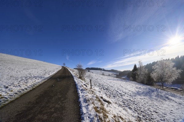 Hilly winter landscape, snow, road, deep blue sky with cirrostratus clouds, Titisee-Neustadt, Black