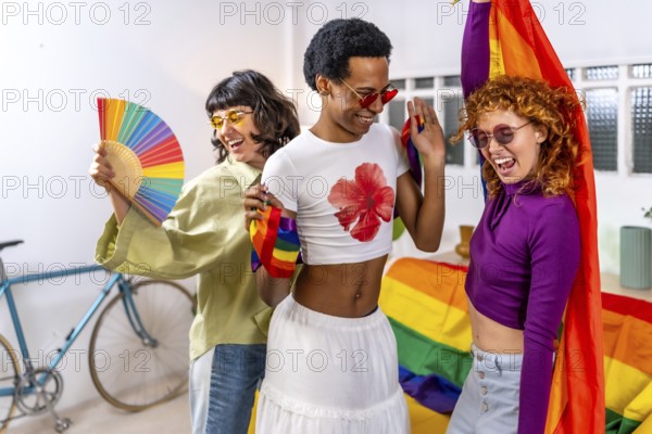 Happy multi-ethnic and gender diverse friends celebrating pride party at home wearing sunglasses