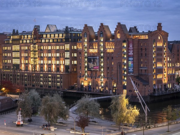 Aerial view of the International Maritime Museum Hamburg surrounded by trees during the blue hour