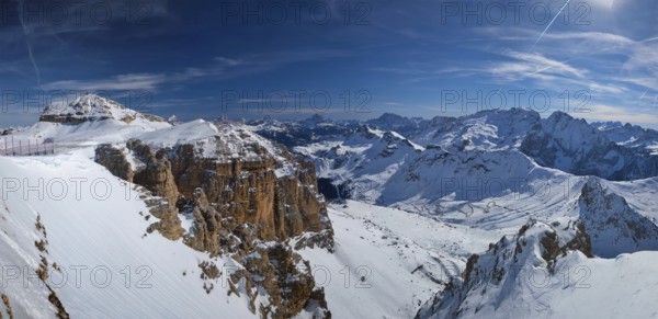 Panorama of a ski resort piste and Dolomites mountains in Italy from Passo Pordoi pass. Arabba,