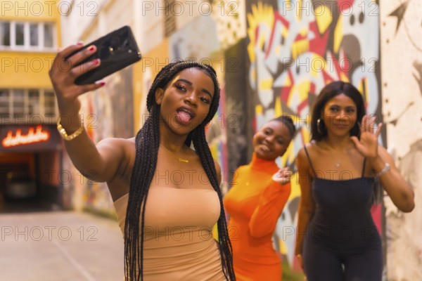 San Sebastián, Gipuzkoa Spain, February 2021: Three girls taking a selfie. Fashionable urban style