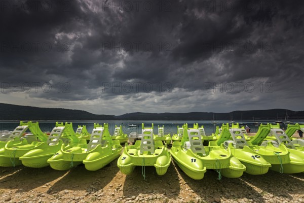Pedal boats on the beach in Sainte Croix du Verdon, Lac de Sainte-Croix, thunderstorm atmosphere,