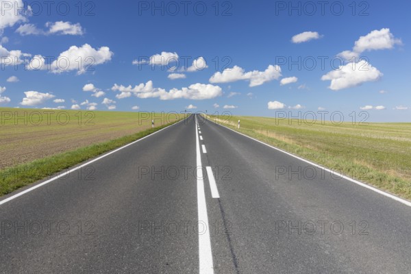 Straight country road, B173 between Dresden and Freiberg, without cars, blue sky with fair weather
