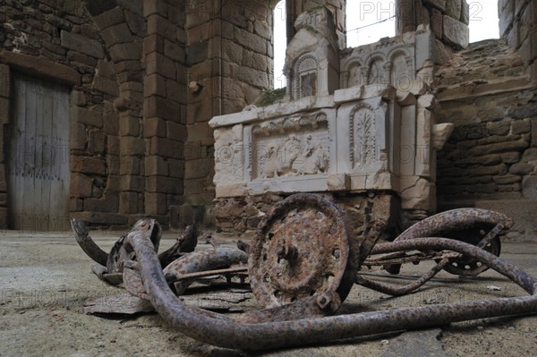 Burnt pram and altar in the church. The burnt village of Oradour-sur-Glane was destroyed on 10 June