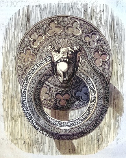 A finely chiselled iron ring, door handle on one of the inner doors of Bourges Cathedral, France,