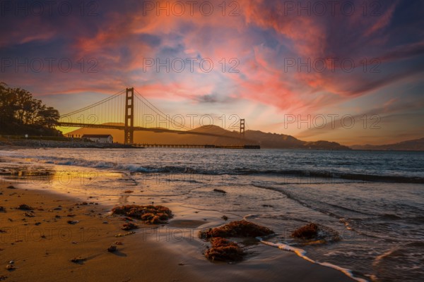 Gorgeous orange sunset with pink clouds over the Golden Gate in San Francisco, California. United