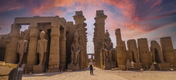 Sculptures of ancient Egyptian pharaohs and drawings on the columns of the Luxor Temple in the