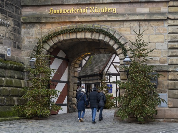 People walking through the Königstor, Christmas trees with fairy lights, Handwerkerhof, Nuremberg,