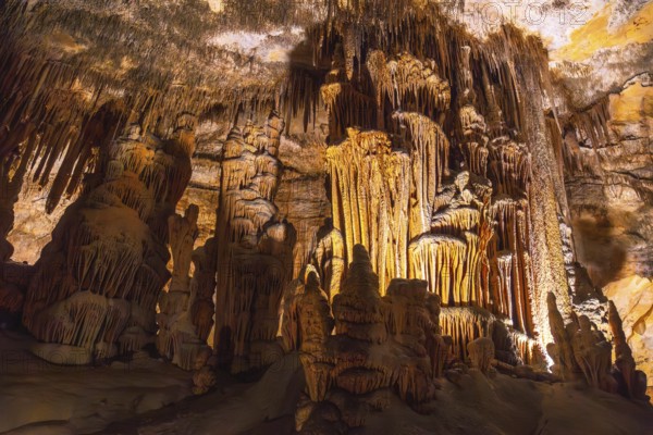 Interior of caves of drach illuminated by colorful lights showing stalactites and stalagmites in