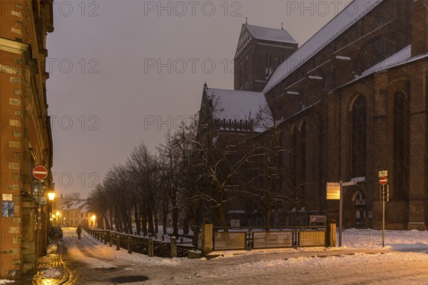St Nicholas' Church and Frische Grube canal in the snow and at night, Hanseatic city of Wismar,