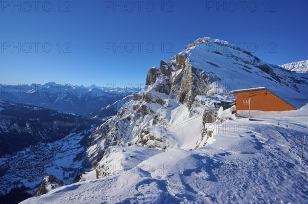 Snow-covered mountain landscape under a clear blue sky, mountain station, Gemmi cable car, Gemmi