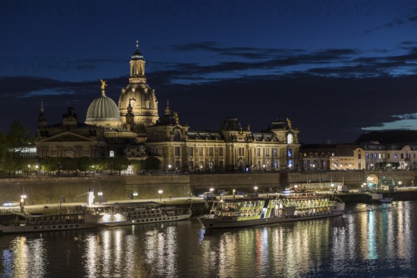 City view with Elbe in the evening, steamer departure, illuminated silhouette at the blue hour,