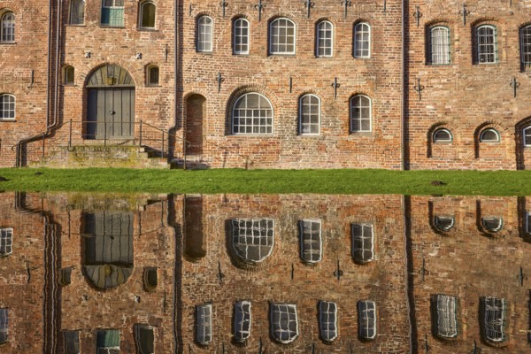 Salt warehouse, historic brick buildings, reflections on the water surface of the Trave, Hanseatic
