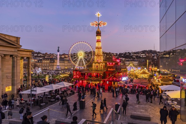 Stuttgart Christmas market at the blue hour. Christmas pyramid on Schlossplatz in front of the New