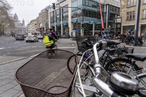 Cycling in the city centre, here at Neumarkt in Cologne, parked bikes and e-scooters at the