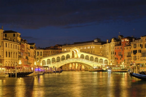 Famous Venetian tourist landmark Rialto bridge (Ponte di Rialto) over Grand Canal with vaporetto