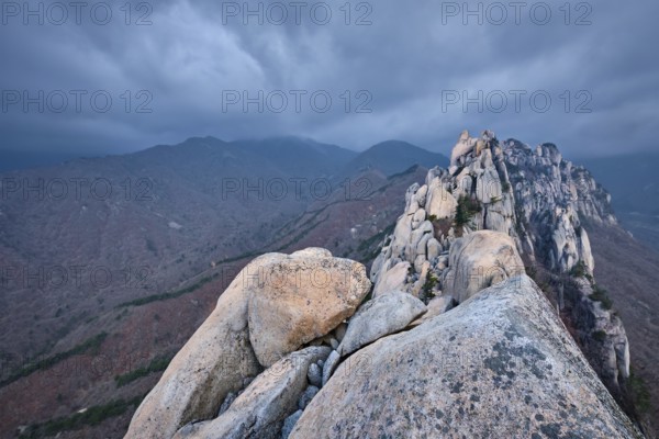 View of stones and rock formations from Ulsanbawi rock peak in stormy weather with clouds.