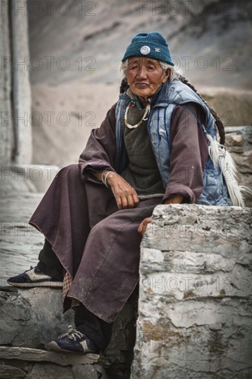 LAMAYURU, INDIA, SEPTEMBER 10, 2011: Old tibetan woman sitting near Lamayuru gompa in Ladakh,