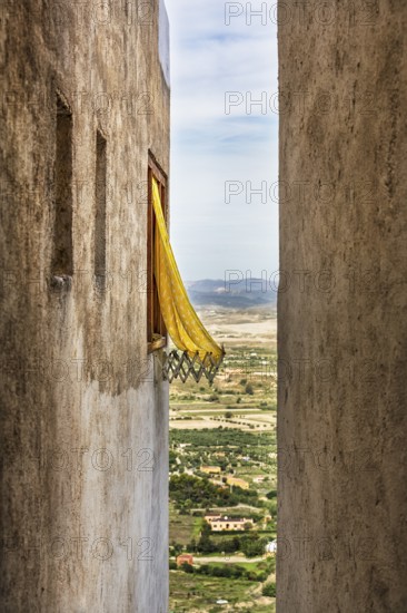 Typical narrow alley with view of the surrounding countryside from above, old town of Mojácar,