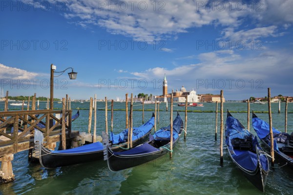 Gondolas and in lagoon of Venice by Saint Mark (San Marco) square with San Giorgio di Maggiore