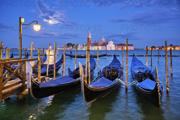 Romantic vacation Venice travel background, gondolas at Saint Mark (San Marco) square and Basilica