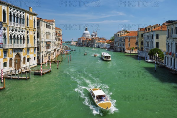 VENICE, ITALY, JULY 19, 2019: View of Venice Grand Canal with boats and Santa Maria della Salute